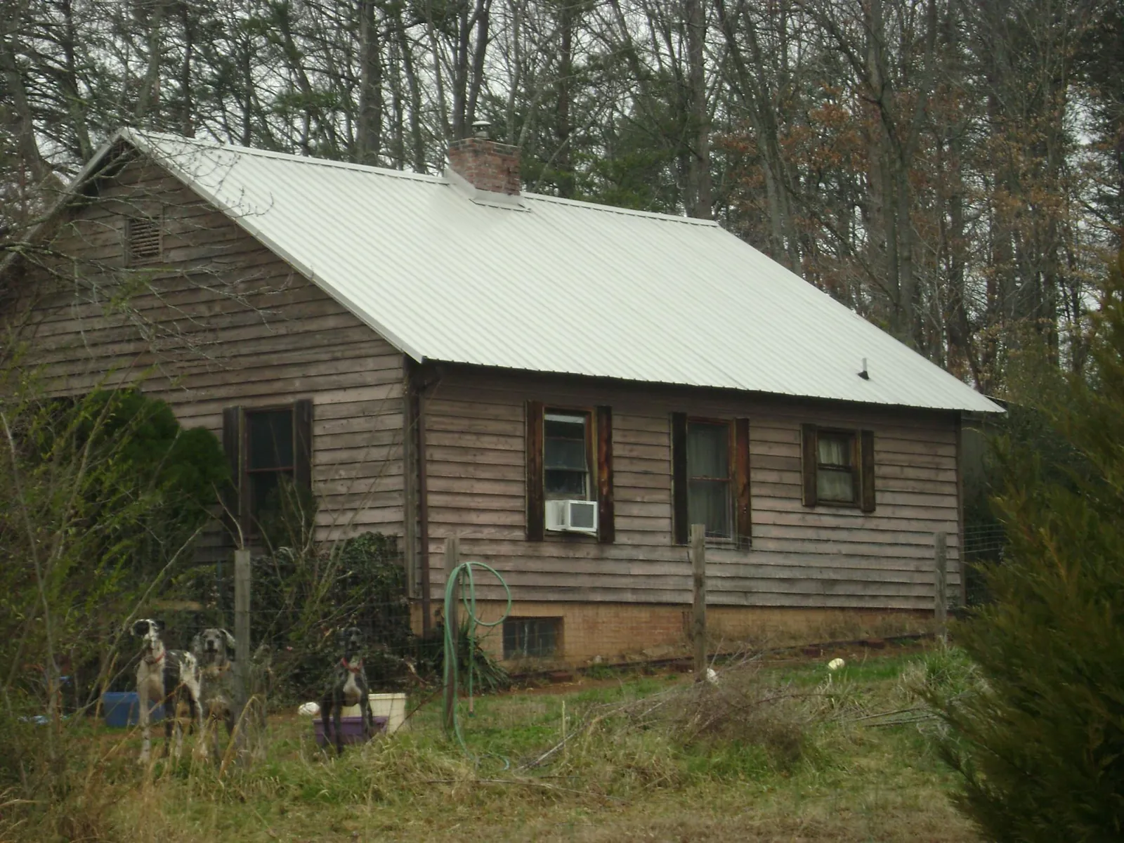 White metal roof on an old wood sided farmhouse, from a Metal Roof Installation job in Spurgeon